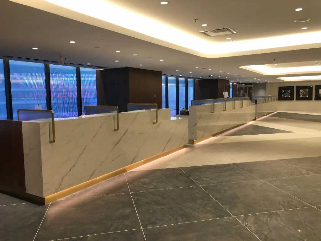 Commercial Custom Millwork | Warm Home Inc Luxury commercial lobby with white marble reception desks and custom millwork by Warm Home Inc